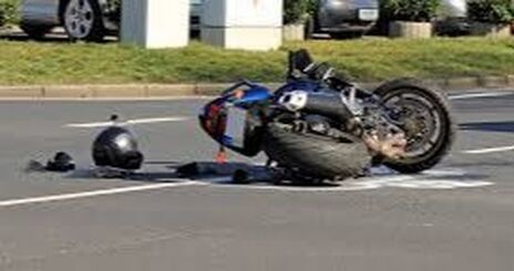 A motorcycle lays damaged on a Lehigh Valley roadway from a traffic accident, with the operator's helmet laying next to it.